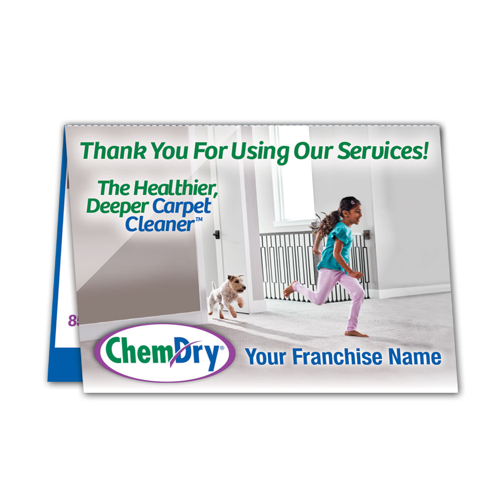 front view of a custom printed ChemDry tent style folded leave behind card with girl and dog running on clean carpet