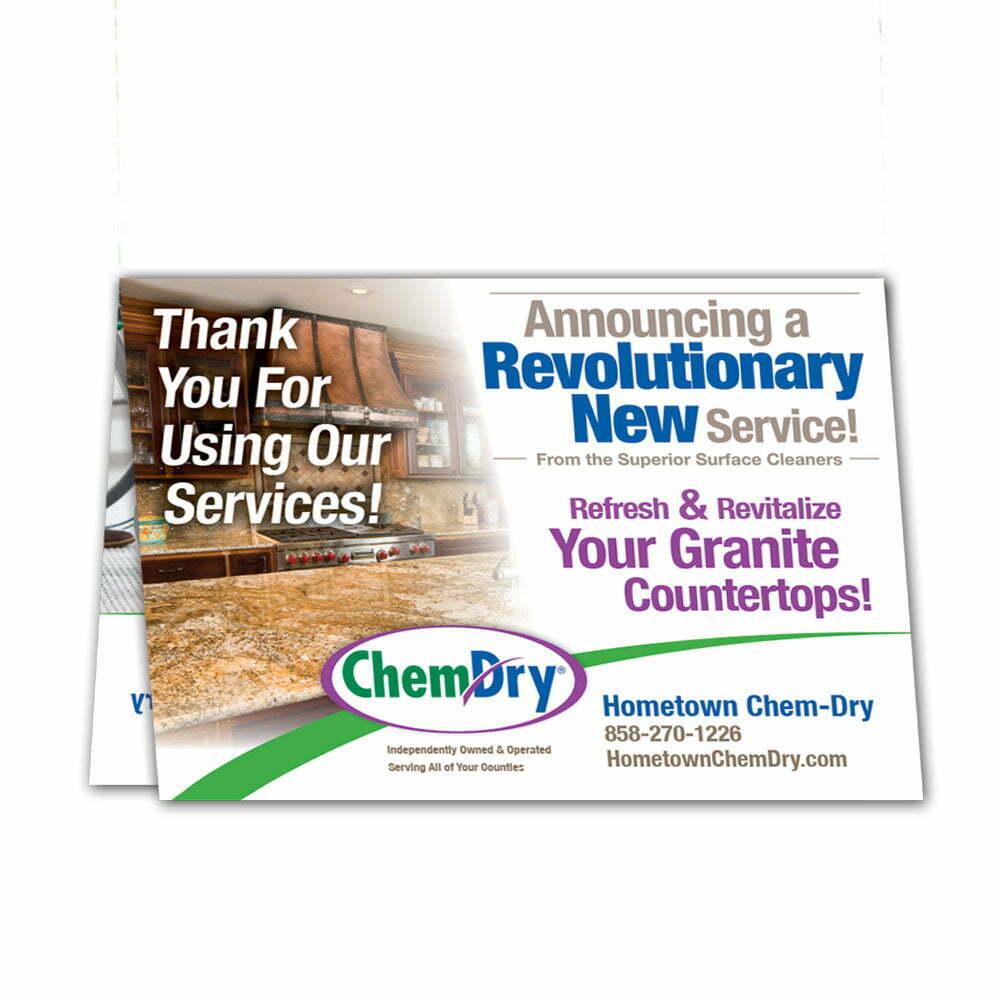 front view of a custom printed ChemDry tent style folded leave behind card with granite countertop
