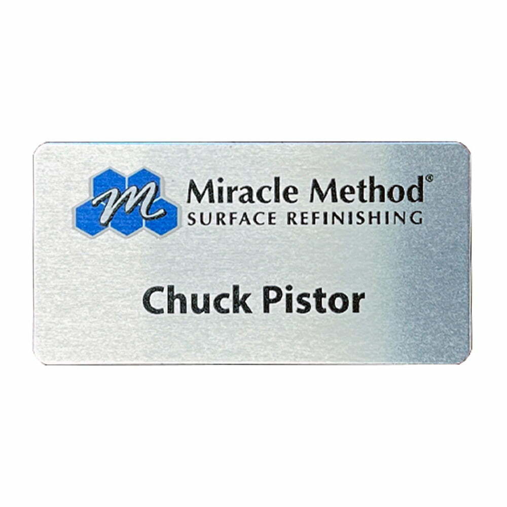 front view of a custom printed Miracle Method metal name tag