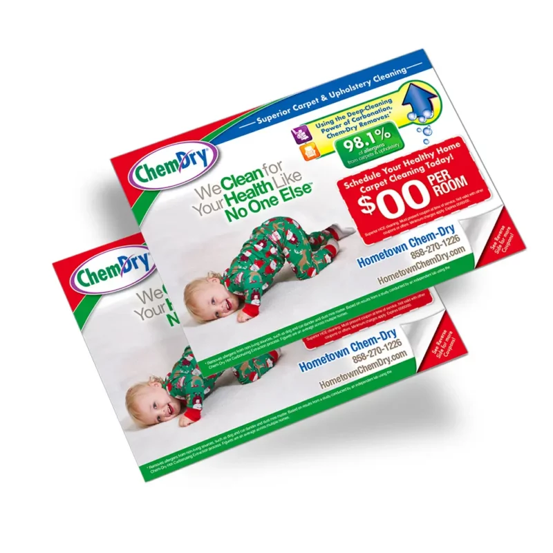 Front side profile view of two custom printed ChemDry branded postcards with baby in Christmas clothes playing on clean white carpet