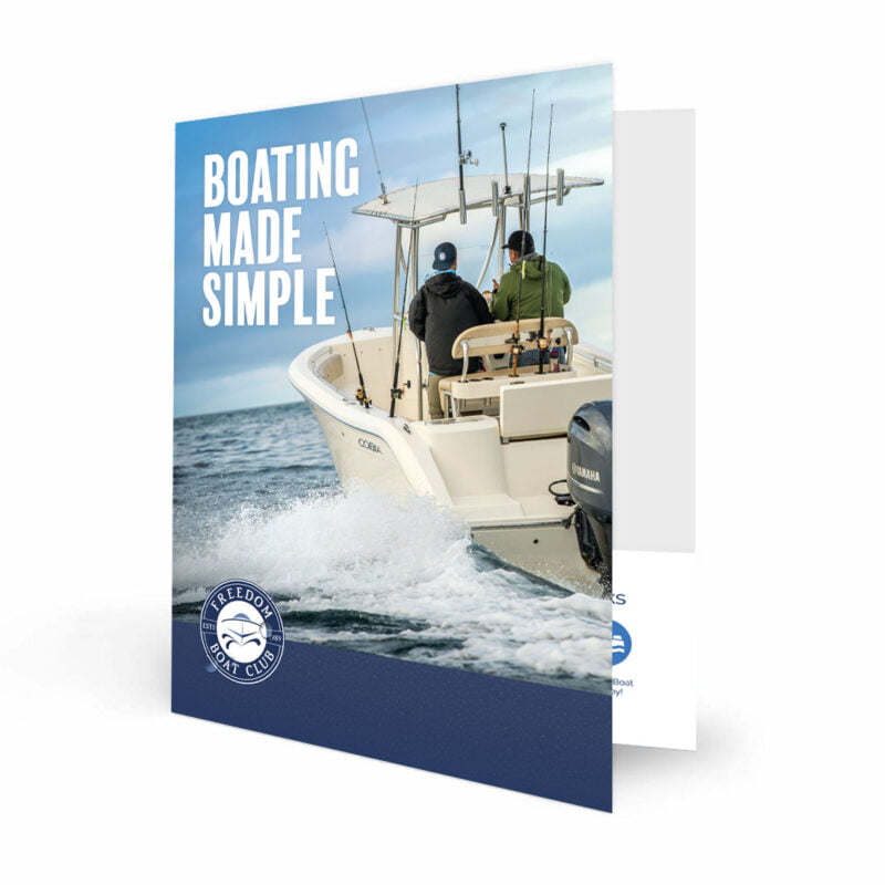 front profile view of a custom printed freedom boat club presentation folder with a boating driving in the ocean