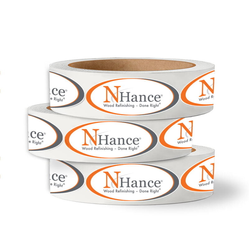 A stack of three custom printed rolls of N-Hance branded labels